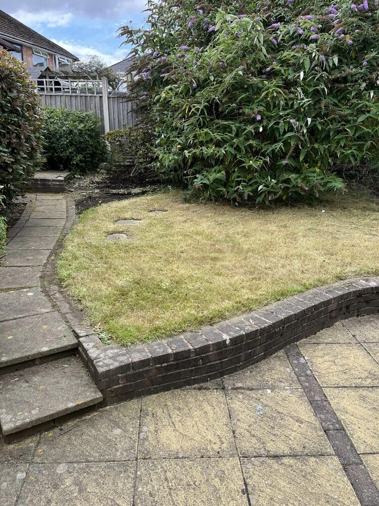 Before: A walled garden cleared and the lawn brought back.